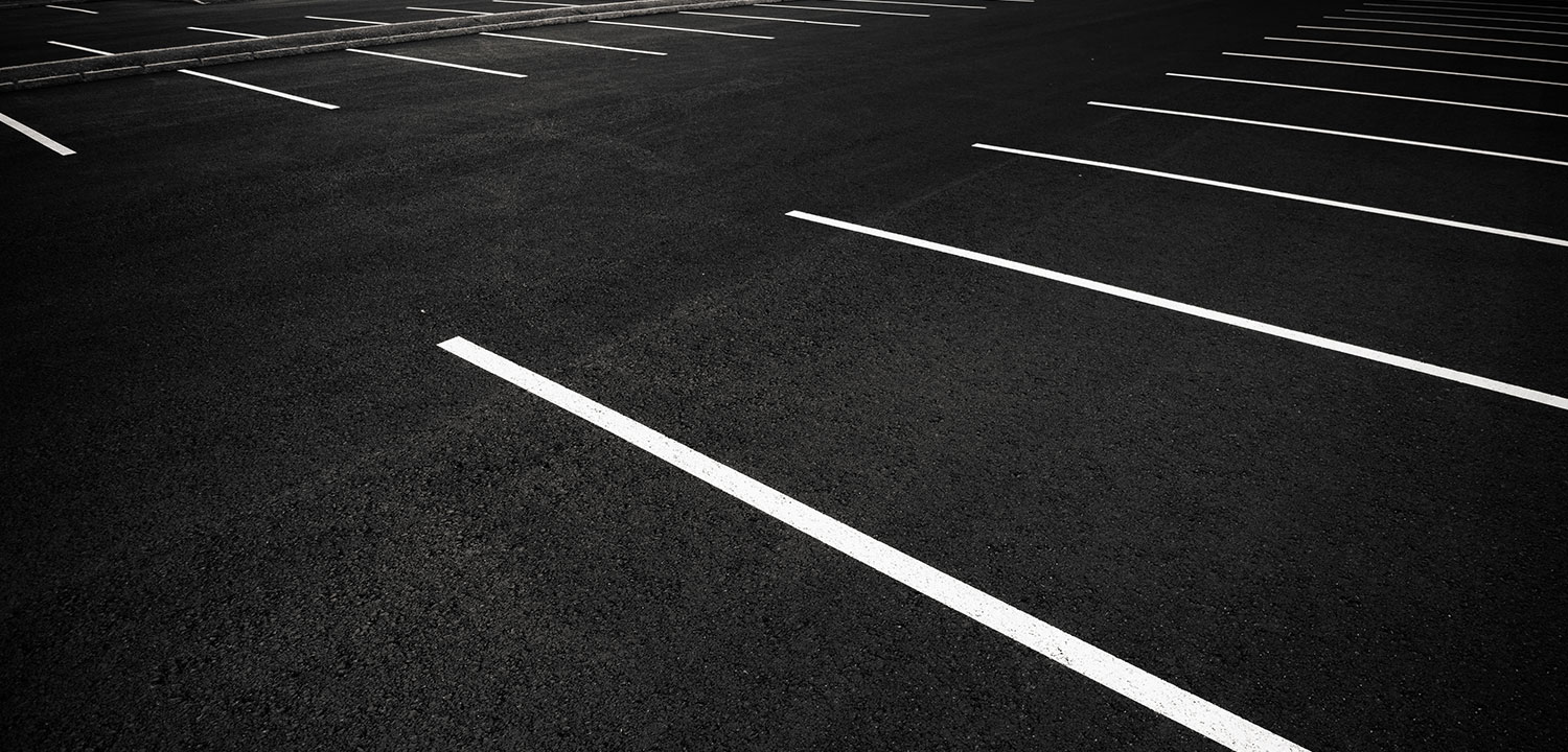 A clean parking lot with dark asphalt.