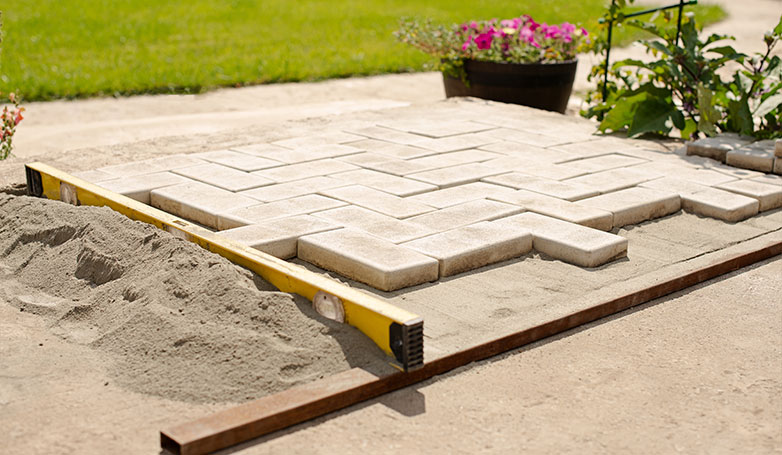 A sandstone driveway is being built