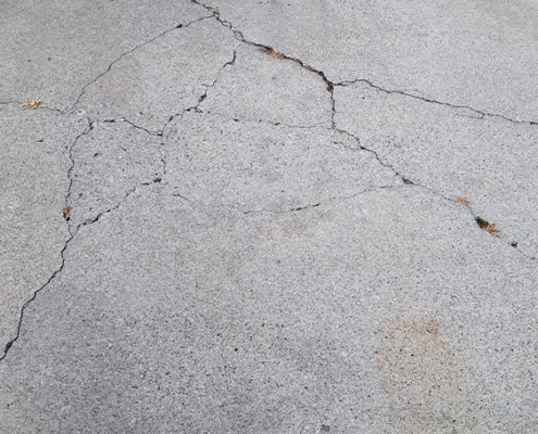 How to repair cracks in concrete driveway