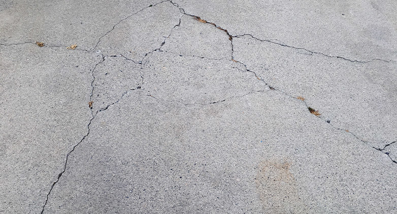 how to repair cracks in concrete driveway