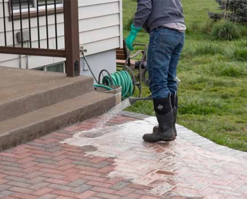 A cleaner cleaning patio brick