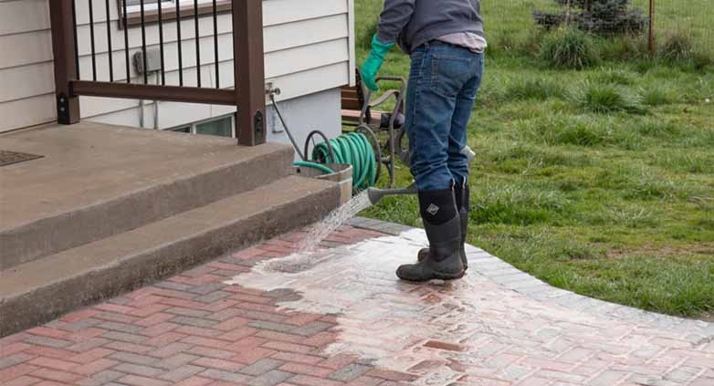 A cleaner cleaning patio brick