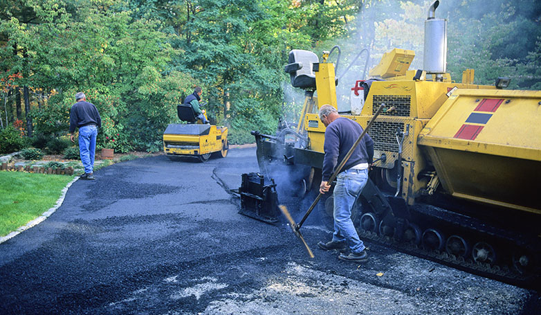 The driveway is under construction for new layer of asphalt