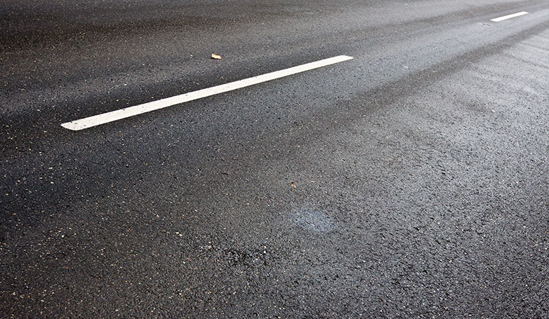 A wet surface of blacktop road