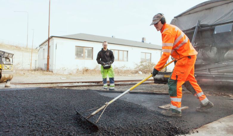 The paving company is asphalting a road
