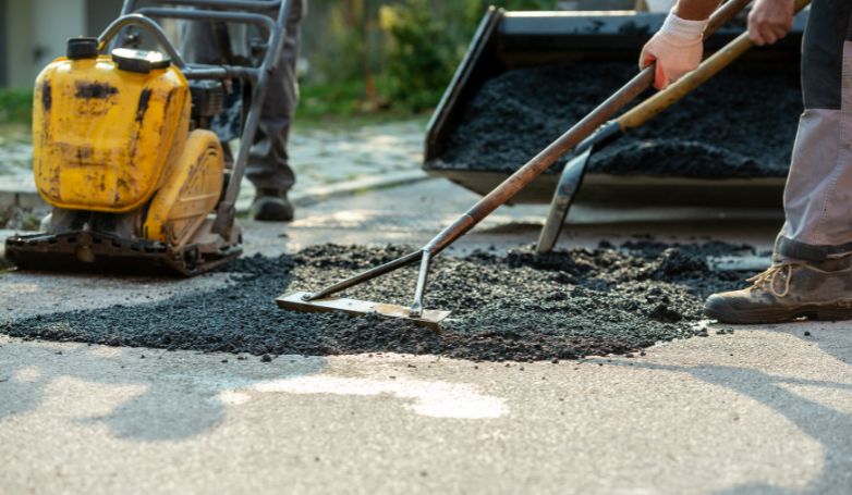 Workers are applying a specific type of asphalt called UPM