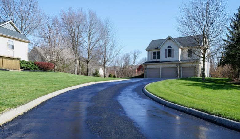 A newly asphalt driveway in front of the big house