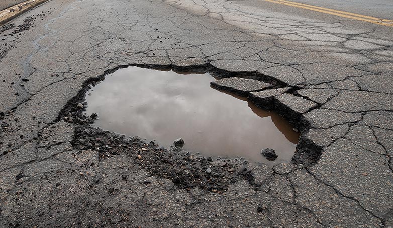 A pothole created in the asphalt was filled with water