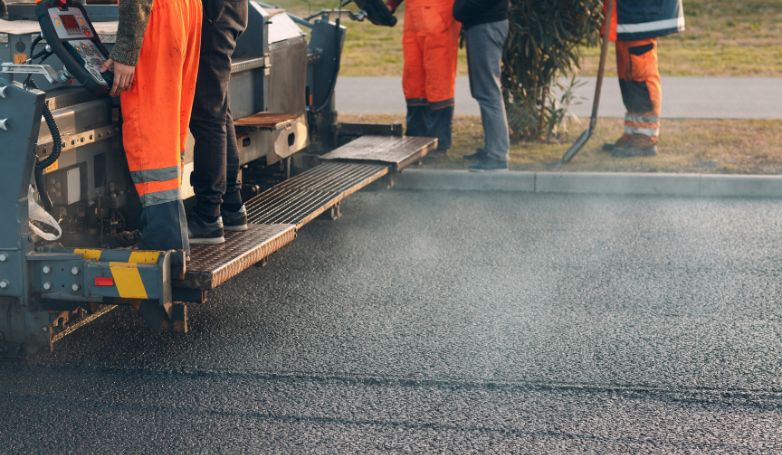 Workers are resurfacing the asphalt driveway